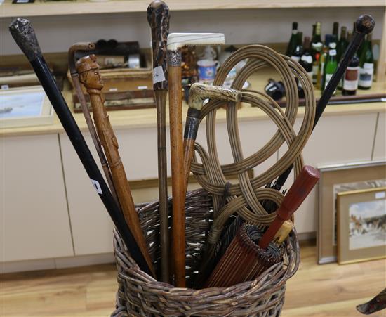 A collection of walking sticks in a wicker basket